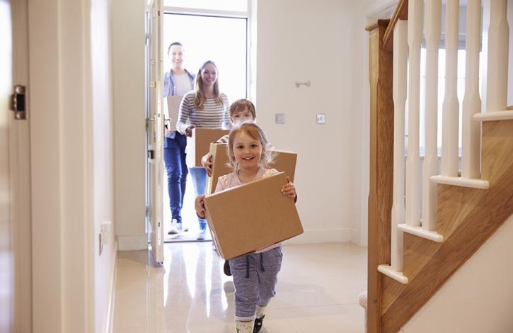 happy_family_carrying_moving_boxes_in